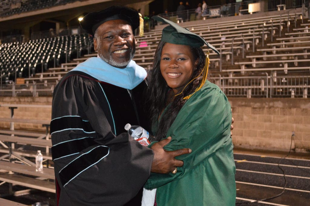 Dr. Harris takes a moment after presenting his daughter (Class of 2016) with her high school diploma.