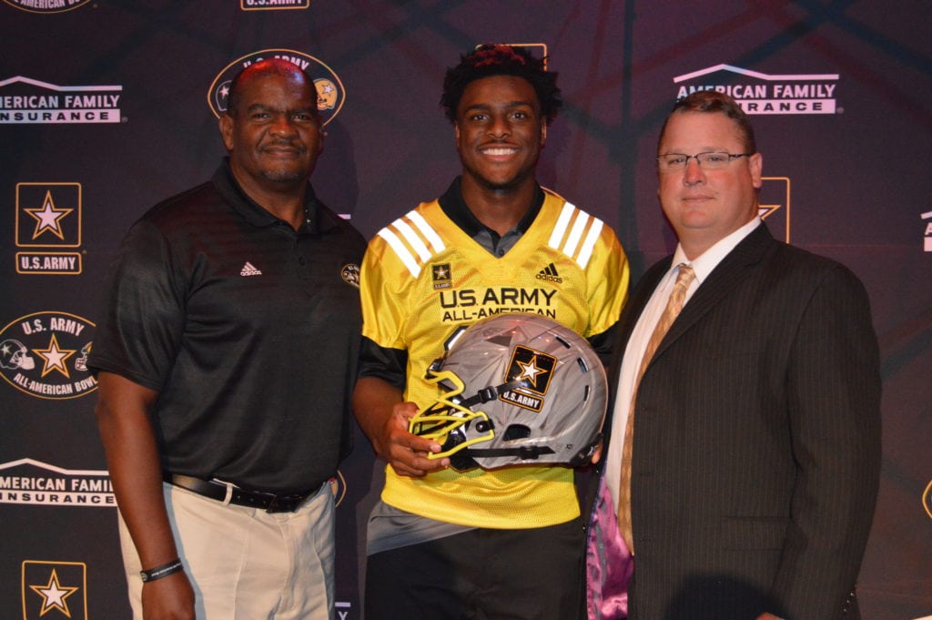 Shawn Robinson holds the Army All-American helmet with Anthony Williams, Texas Dir. Of Player Development /Scouting for the All-American Games and DeSoto Eagles Head Coach Todd Peterman. (Submitted Photo/DeSoto ISD Media Relations)