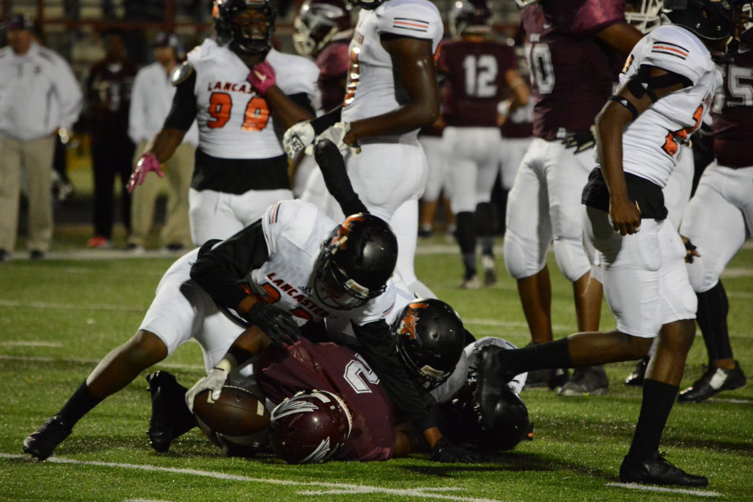 Lancaster High School linebacker Sir Charles Miles-Frost (32) tackles Red Oak running back Blake Sonnier (2) in the 1st half of the Tigers' game against the Hawks at Red Oak's Billy Goodloe Stadium. The Lancaster Tigers beat the Hawks 46-7 at Red Oak's Billy Goodloe Stadium. (Photo by Joshua Bustamante/Tiger Student Media)