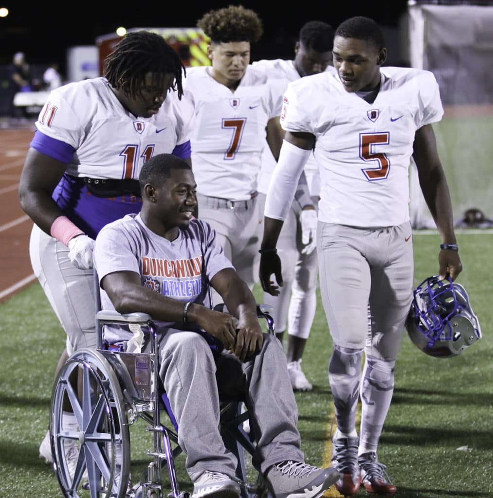 Panthers’ captains wheel injured quarterback Jaylin Nelson onto the field for the first time since his season ending injury last week. Jaylin watched the game from the sidelines and rooted for his backup quarterback and teammates. (Jose Sanchez/Duncanville High School)