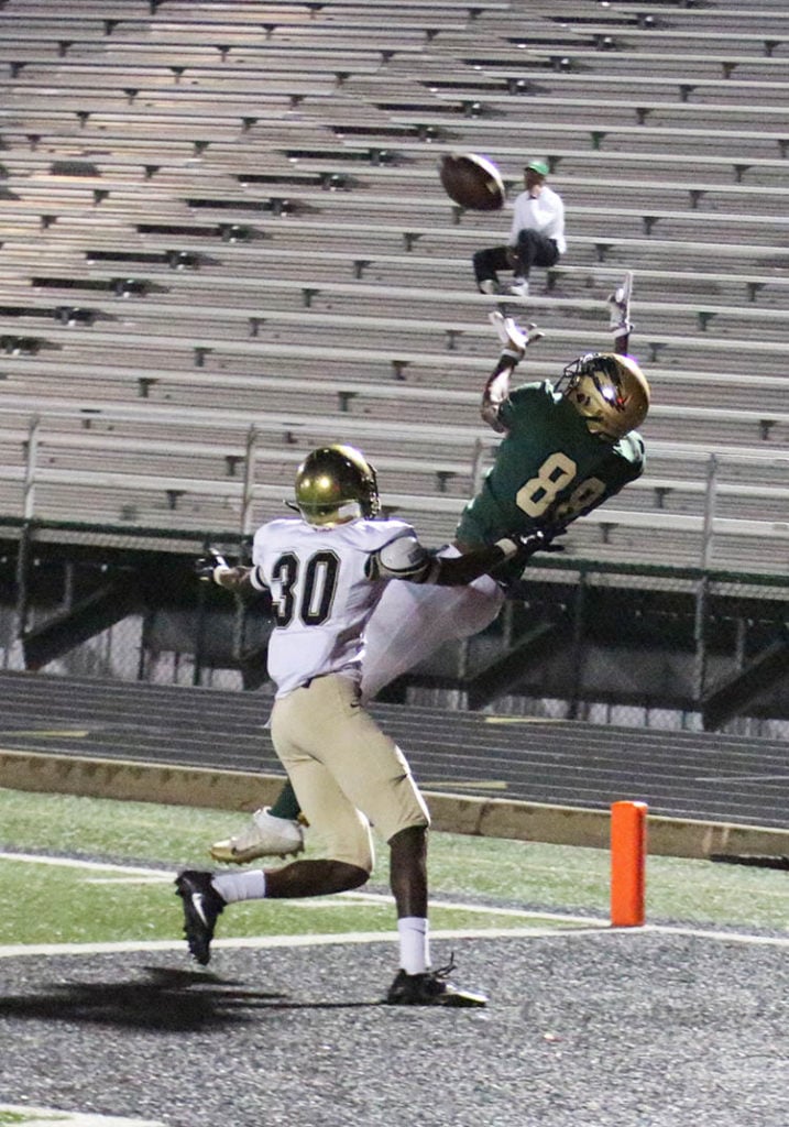 HIGH FLYING: Jarmarius Marshall leaps high to snag a pass from Shawn Robinson in the end zone to make the score 50—7. The PAT was food. (Photo by Marifer Vega/DeSoto High School)