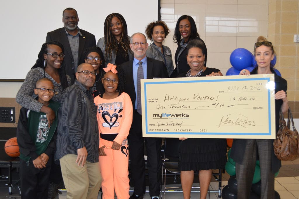 DeSoto ISD officials, event attendees present the $1,000 Scholarship to Addyson Walton at the recent Family Academy, Magnet Showcase.