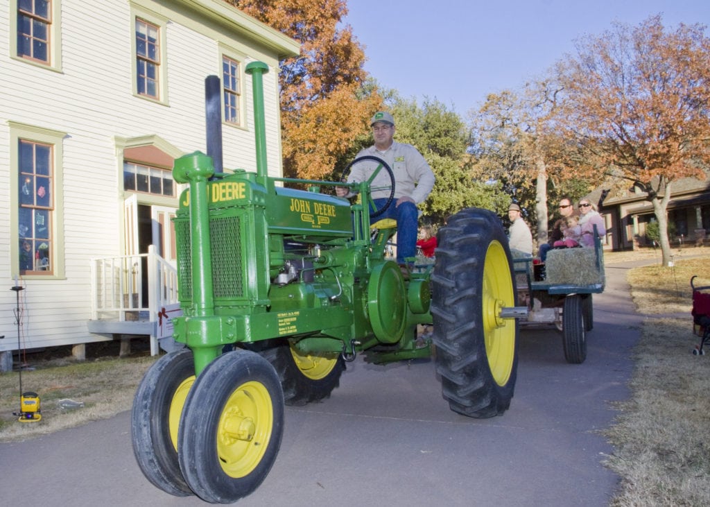 Take a hayride pulled by a vintage tractor at the Dallas Heritage Village.