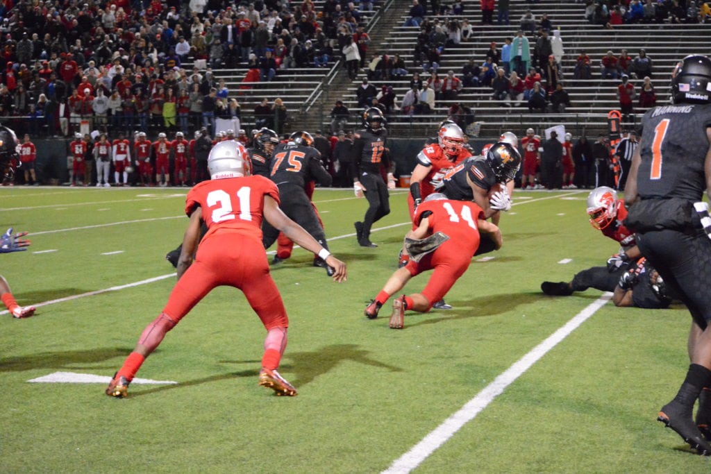 Lancaster High School running back Demadric Williams runs against the Woodrow Wilson defense at Grand Prairie's Gopher/Warrior Bowl. The Lancaster Tigers defeated the Woodrow Wilson Wildcats 58-39 on the strength of Williams' 4 touchdown runs during the game. (Photo by: Joshua Bustamante/Tiger Student Media)