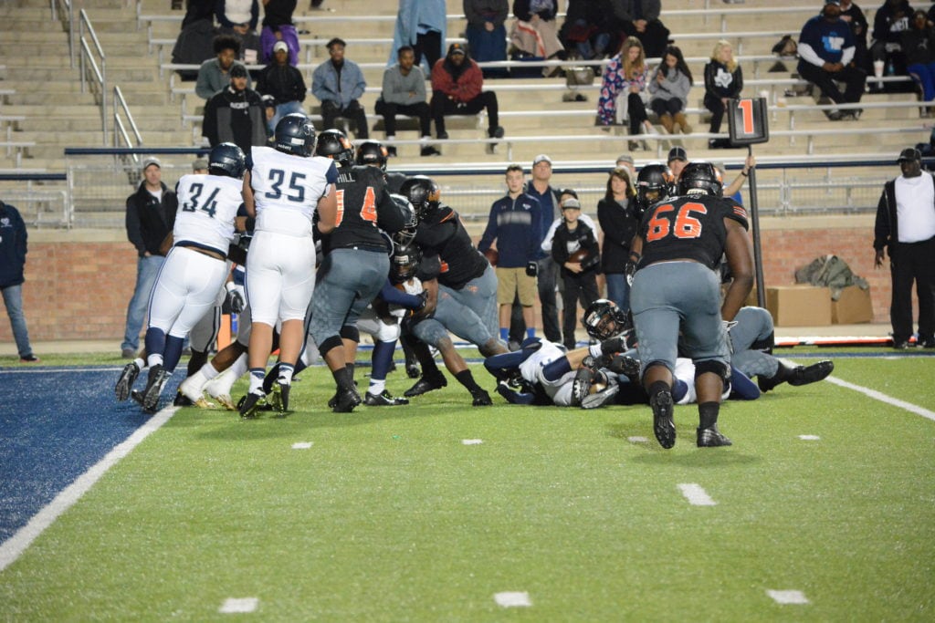 Lancaster High School Running Back Senior Demadric Williams fights for yards near the goal line against the Wylie East defense November 25 at Allen Eagle Stadium. The Tigers beat the Raiders 27-20 in the UIL Regional semifinal round and will face Mesquite Poteet December 2 in Midlothian. (Photo by Joshua Bustamante/Tiger Student Media)