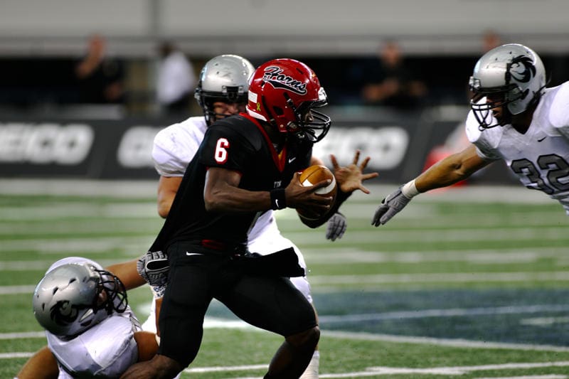 2010 Cedar Hill Quarterback Driphus Jackson (Rice University) battles to gain yardage against the Denton Guyer defense during the Longhorns and Wildcats last playoff meeting in 2010. (File Photo)