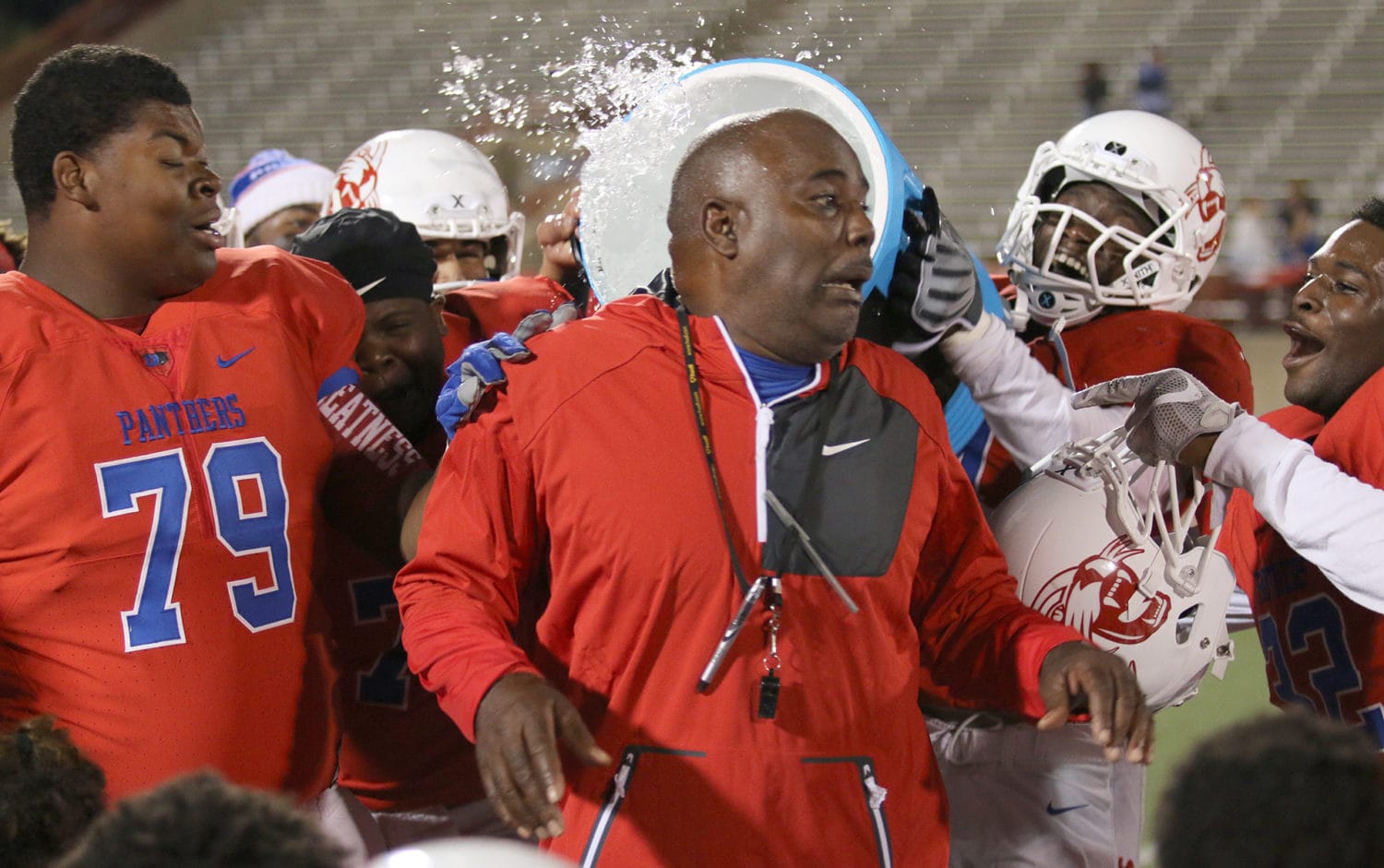 Duncanville players shower Head Coach Reginald Samples after their Bi-District Playoff victory over Harker Heights, Friday, November 11. (Jose Sanchez/Duncanville High School)