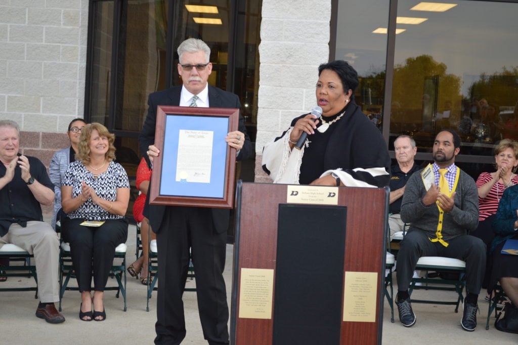 State Representative Yvonne Davis presents Coach Dyer with a resolution from the Texas House of Representatives.