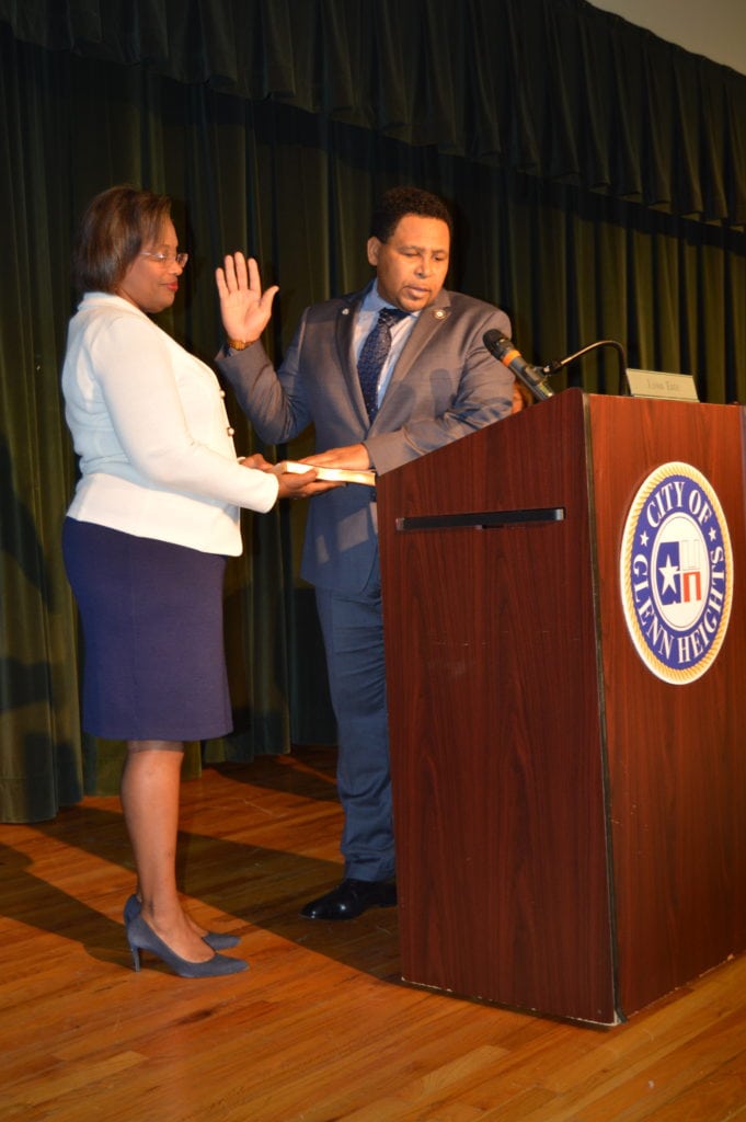 Glenn Heights City Manager Aretha Ferrell-Benavides administers oath of office to Mayor Leon Tate.