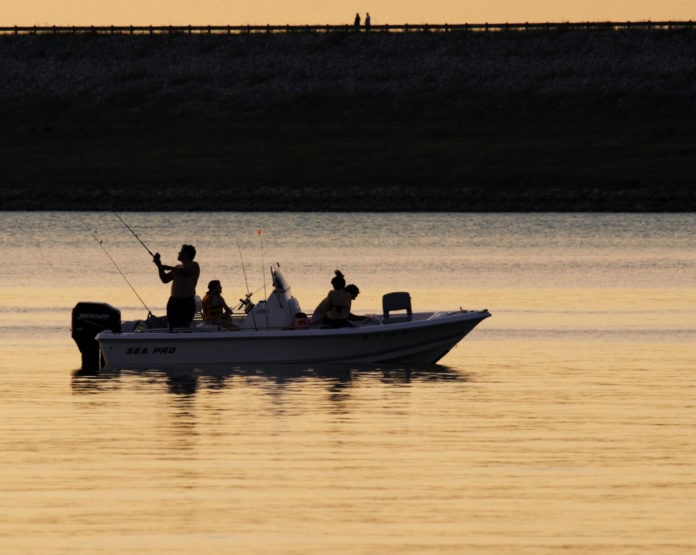 family in boat silhouette arbor day celebration