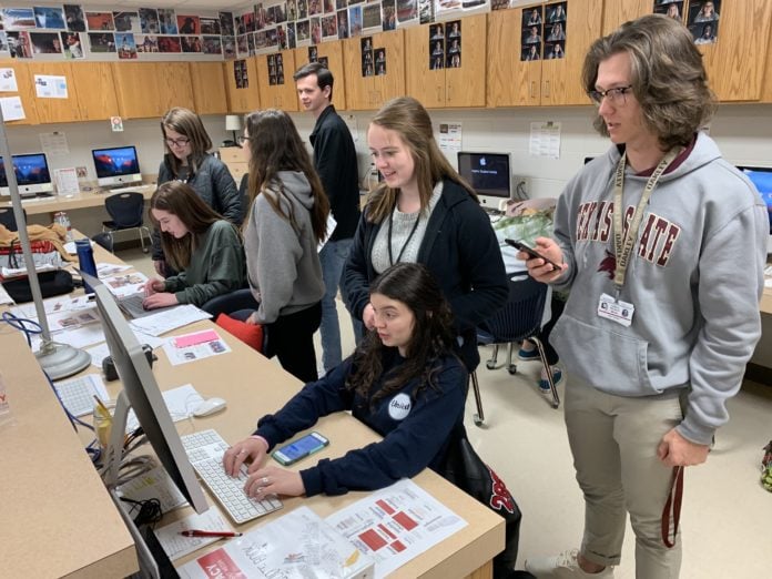 Rider students in front of computers