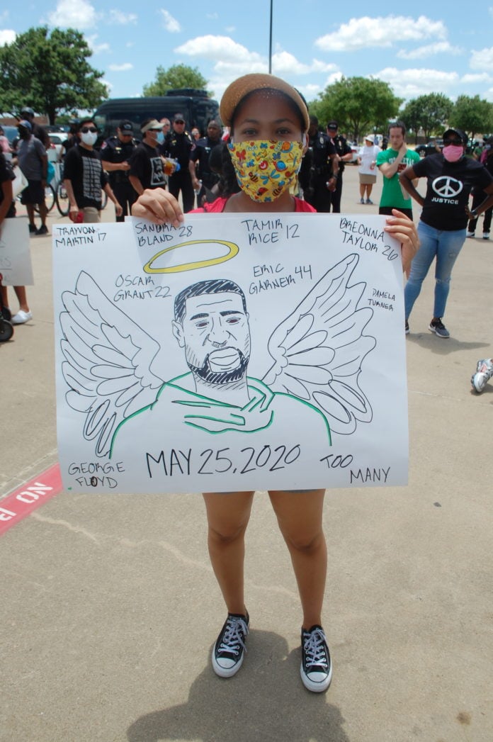 protester holding George Floyd sign