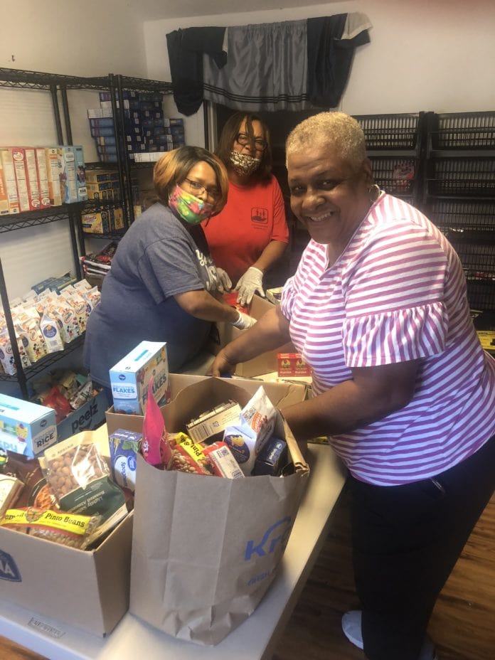 Bethlehem Baptist food pantry ladies pack food bags at food pantry