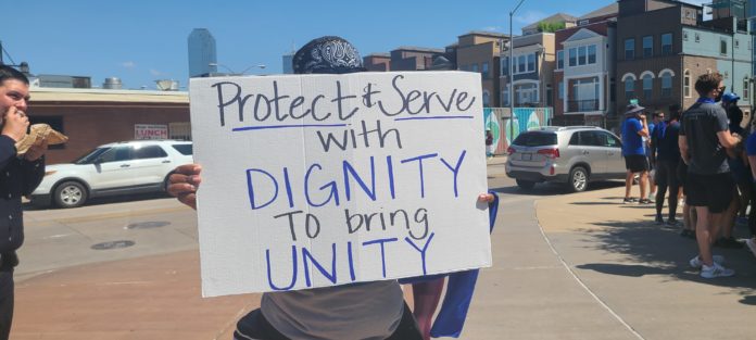 protect and serve protest sign