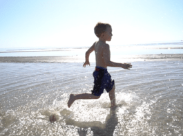 boy running through ocean