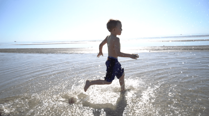 boy running through ocean