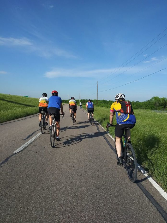 people bicycling on the road