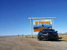 Camaro in front of Wyoming State Sign