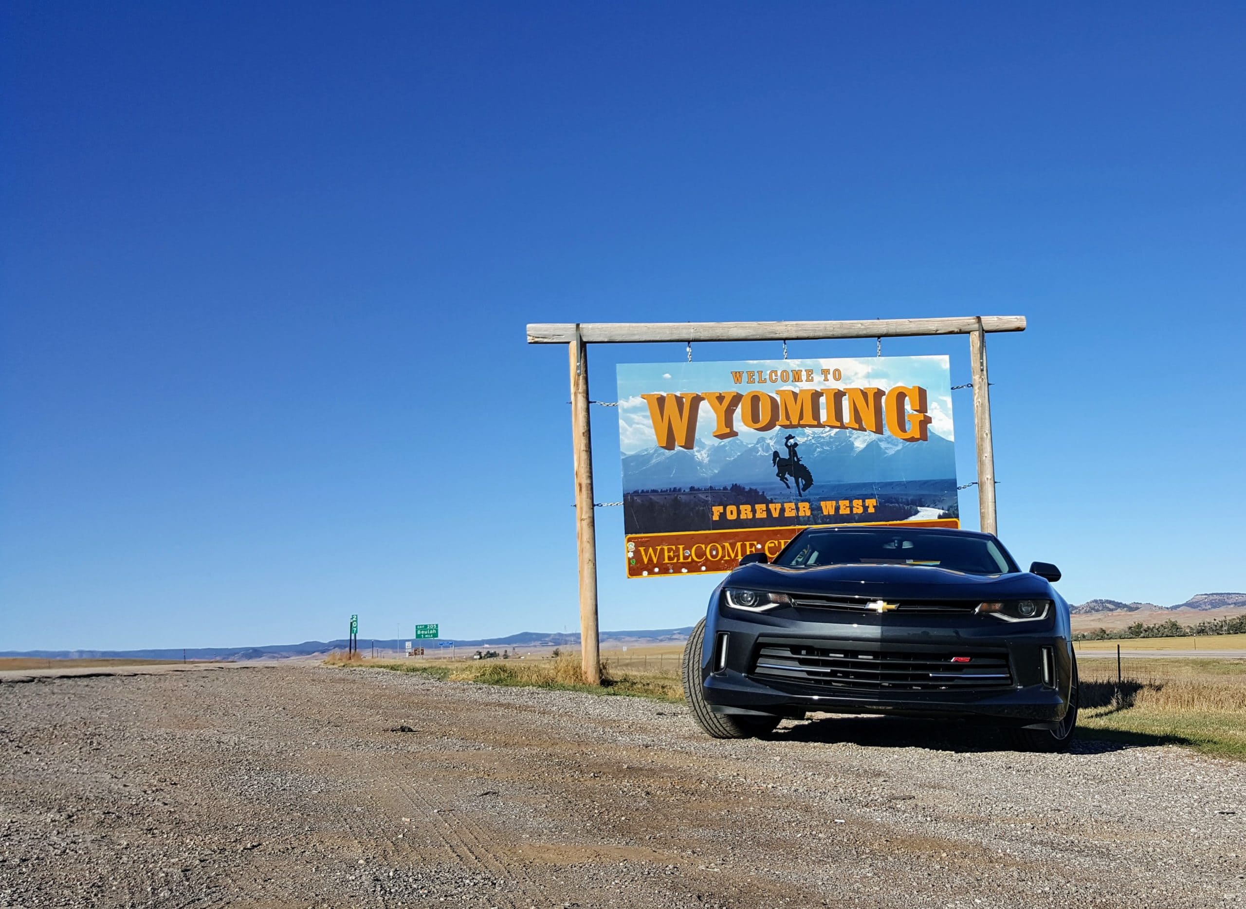 Camaro in front of Wyoming State Sign