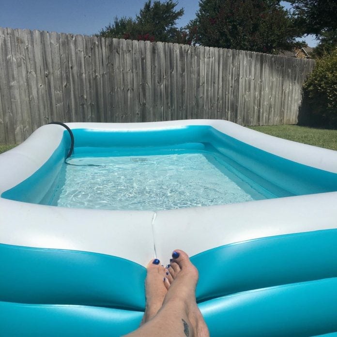 feet resting on inflatable pool