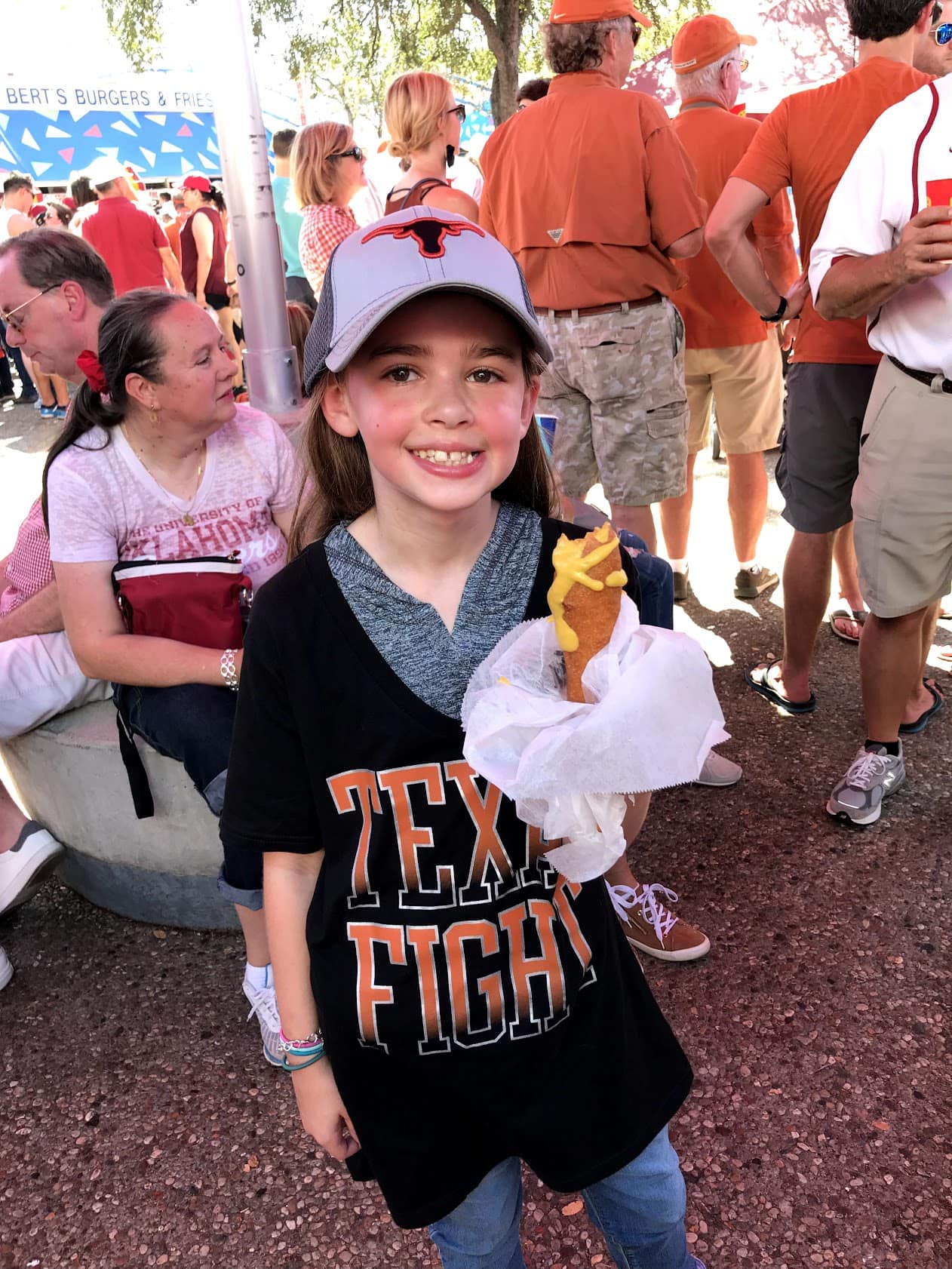 Child eating a Fletcher corny dog at State Fair of Texas