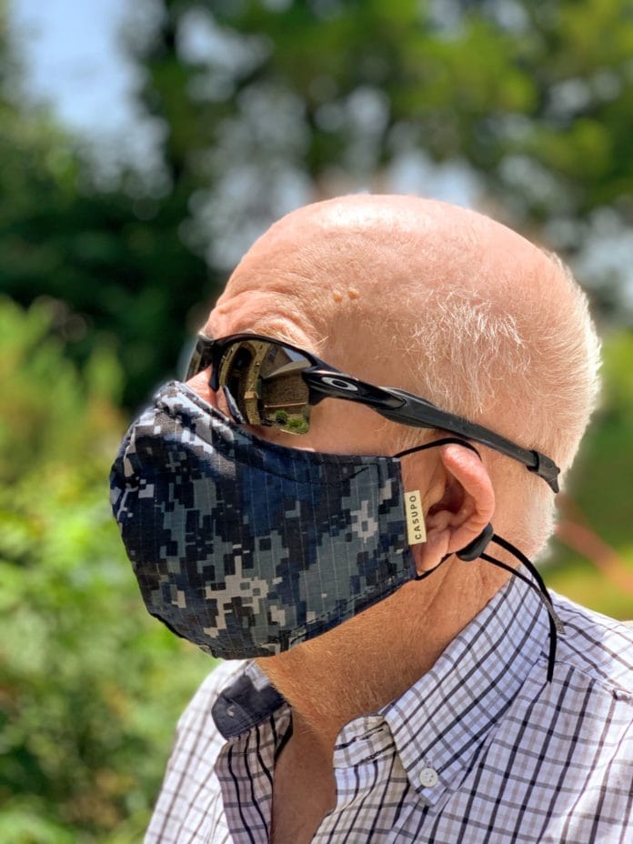 Man wearing navy blue camo face mask