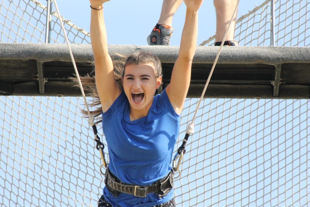 young girl in trapeze harness