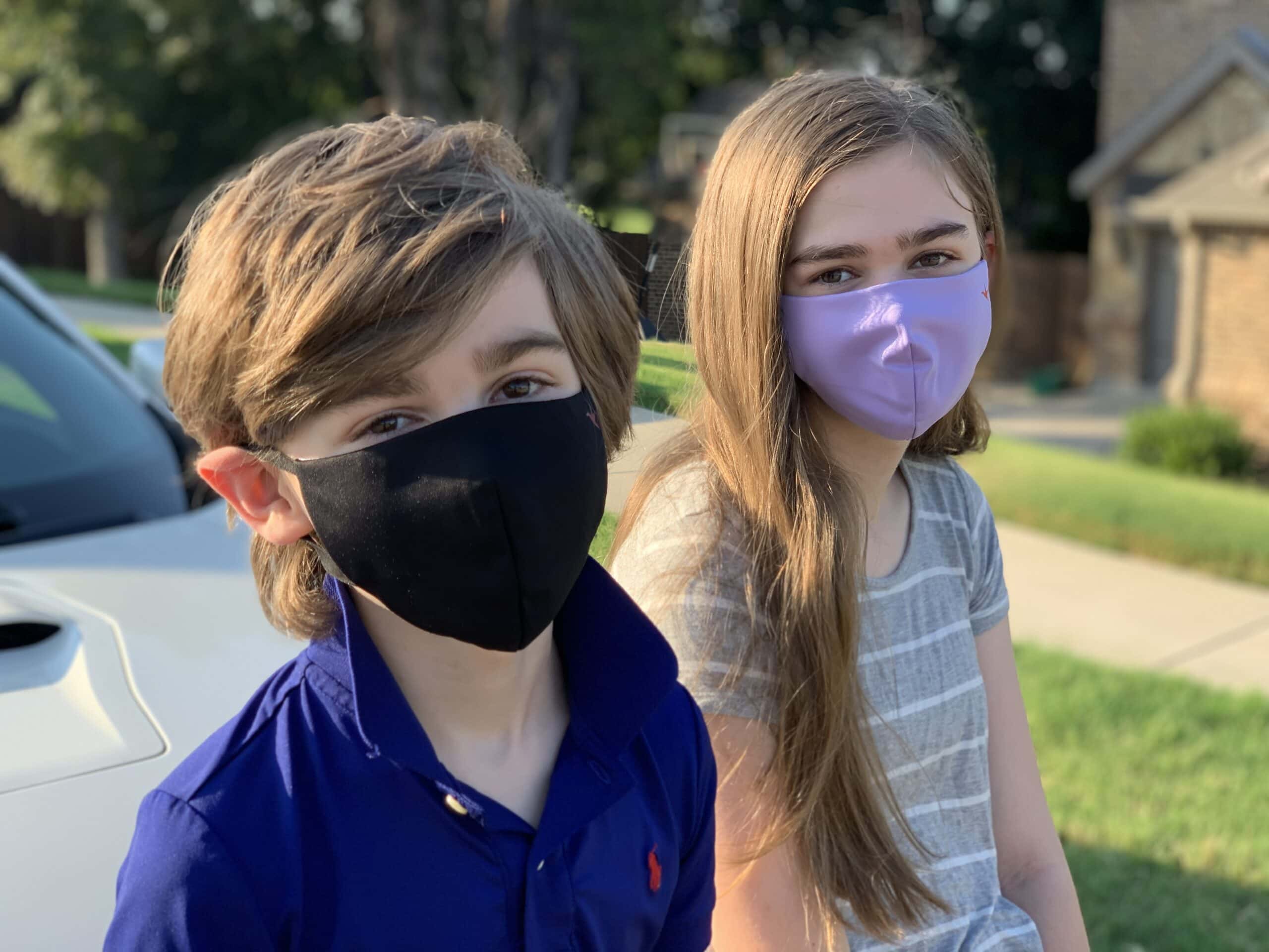 Boy and girl wearing Oura Air Mask Jr.