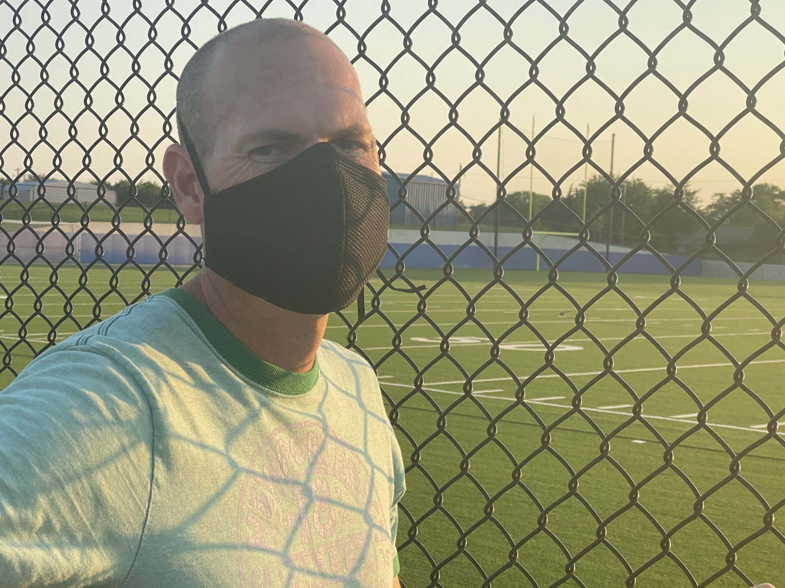 male wearing Sprye face mask from Arsenal wares