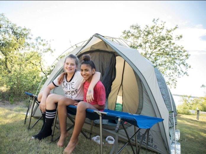 Two girls camping in a tent