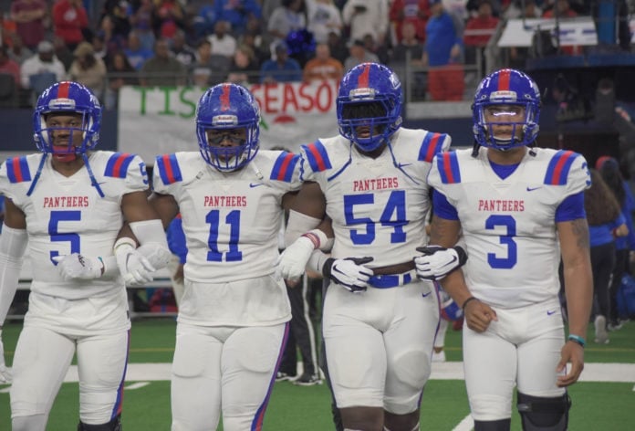 Duncanville football players link arms