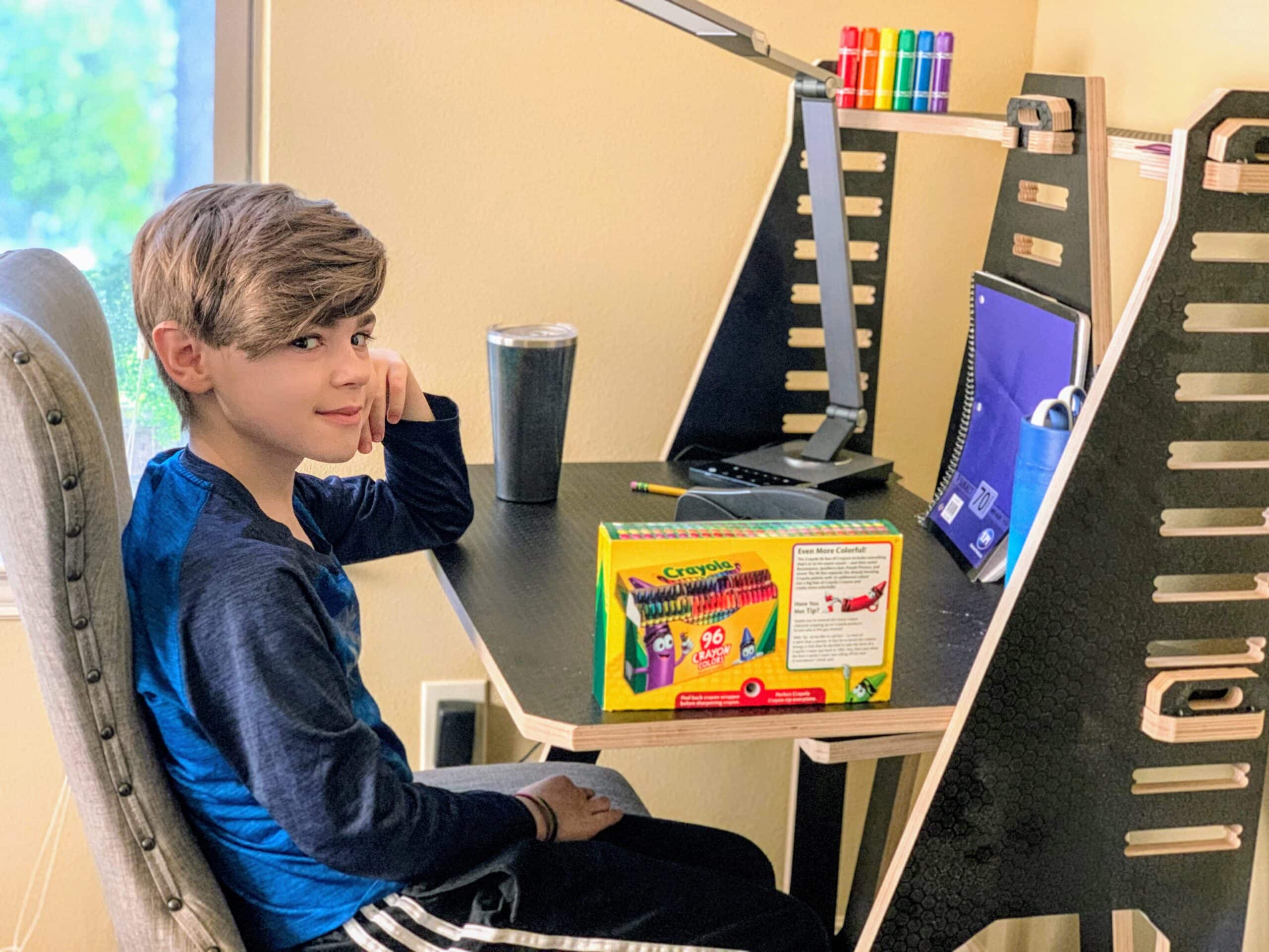 boy sitting at work from home desk