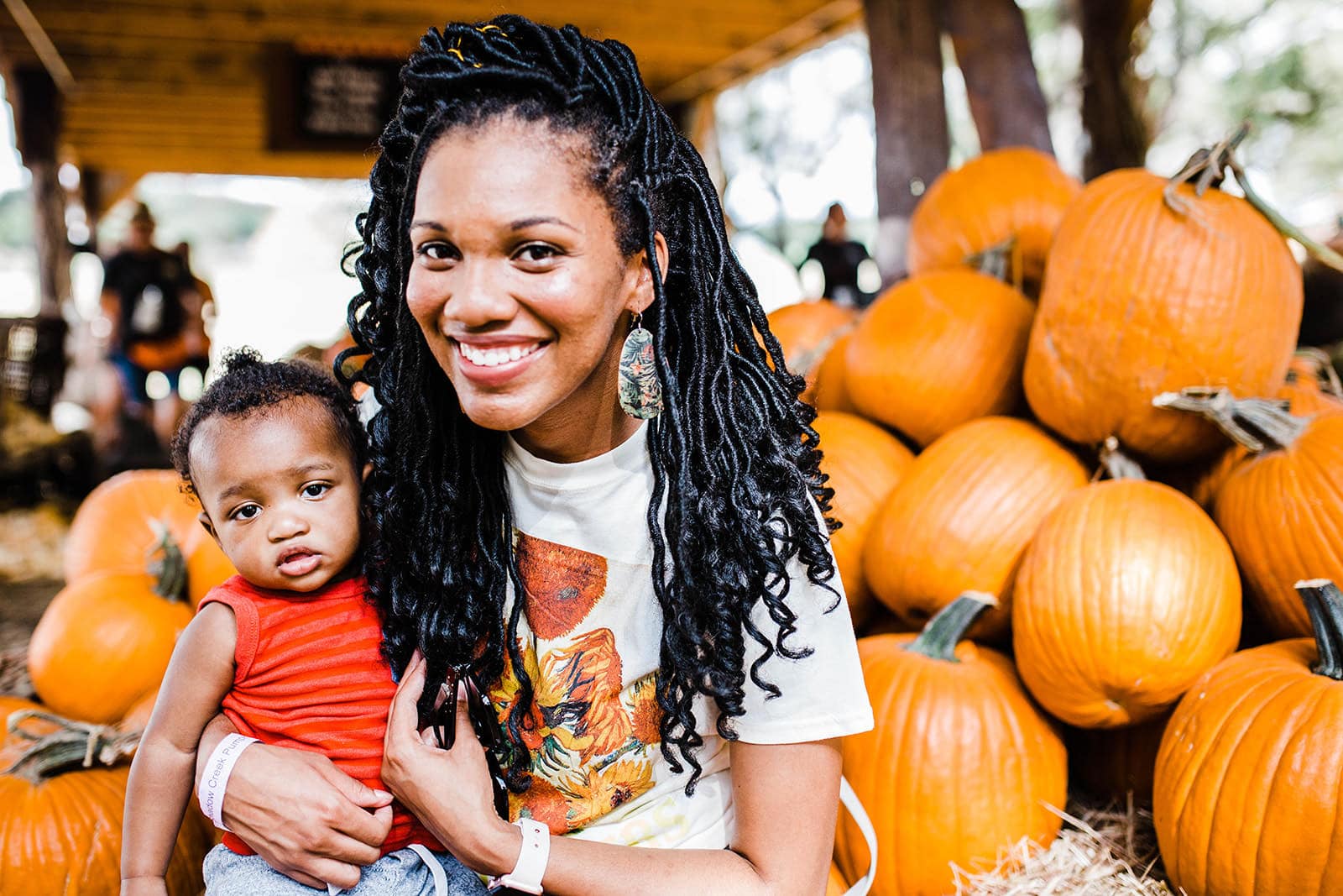 woman with child and pumpkins