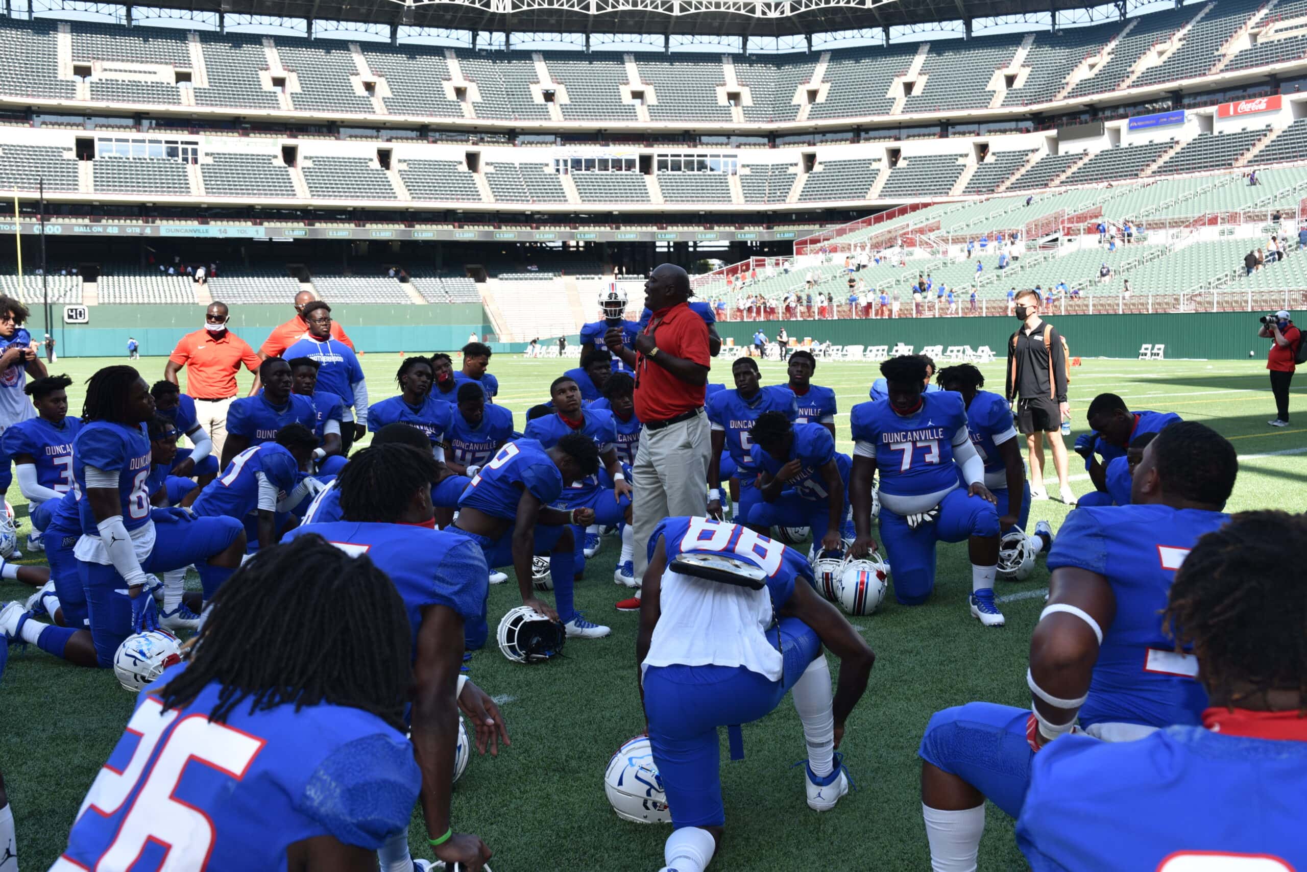 Coach talks to football players