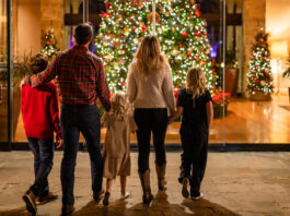 family in front of Christmas tree