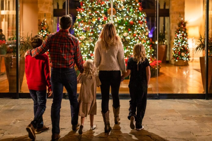 family in front of Christmas tree