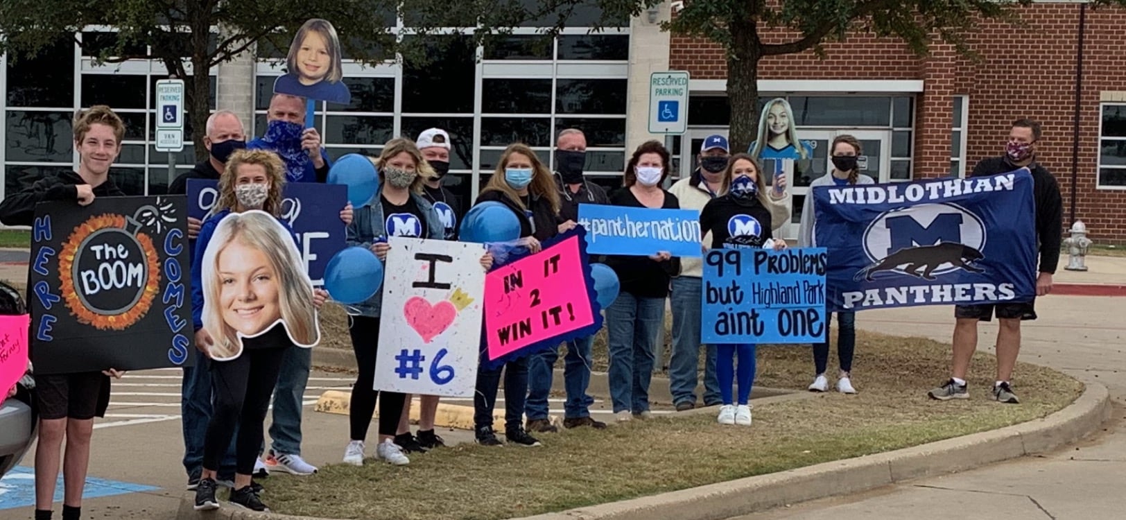 Midlothian fans hold volleyball signs