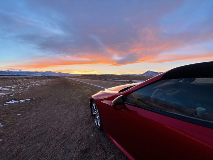 car on road at sunrise