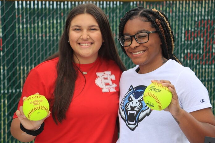 two girls with softballs