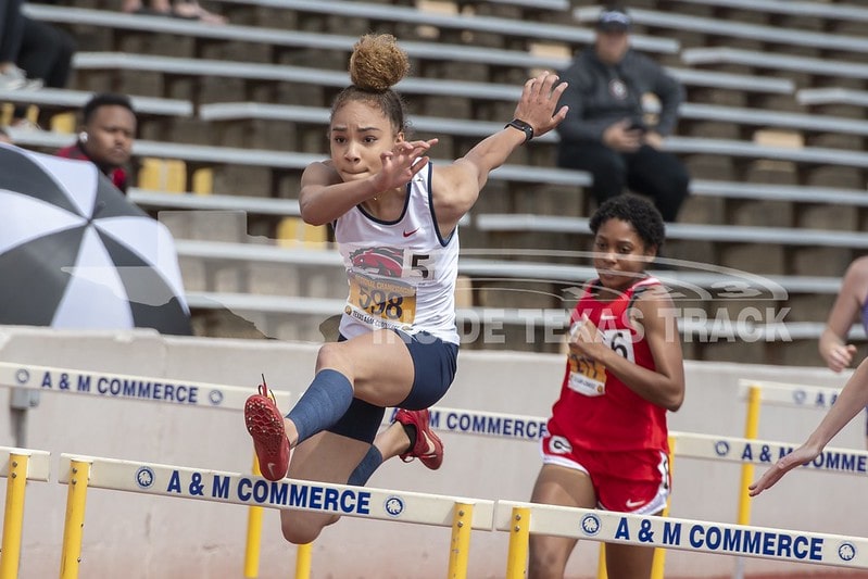 girl jumps hurdle
