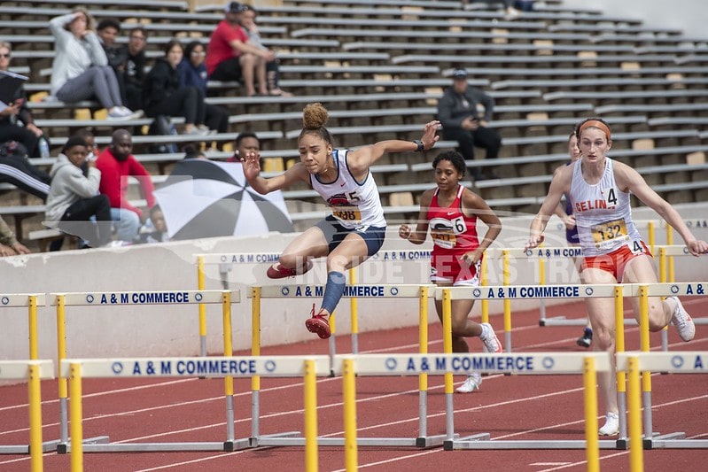 girls jumping hurdles