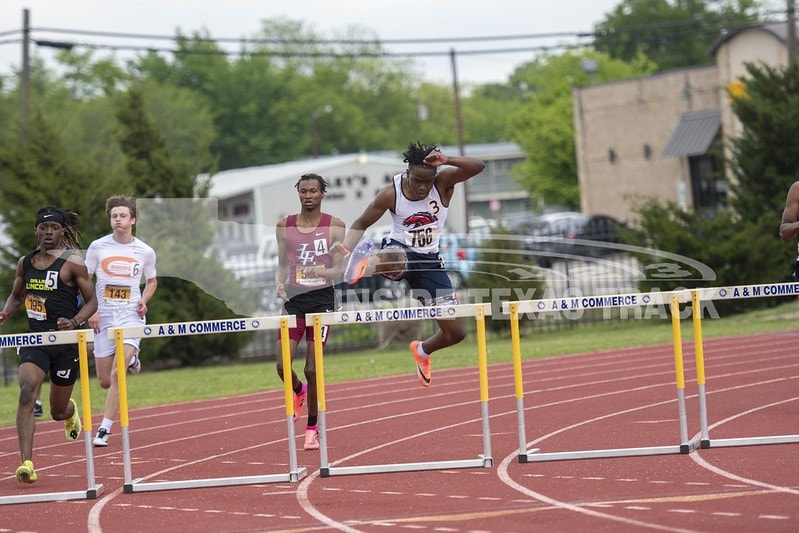 guy jumping a hurdle