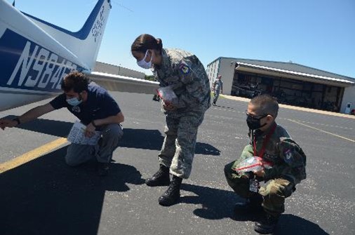 students look at airplane