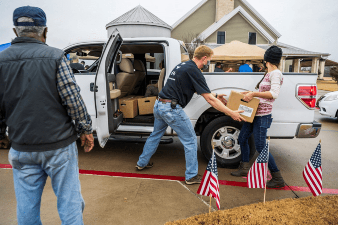 Food giveaway GFA People loading boxes in truck