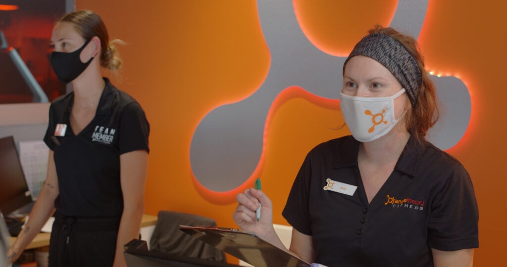 two women wearing face masks