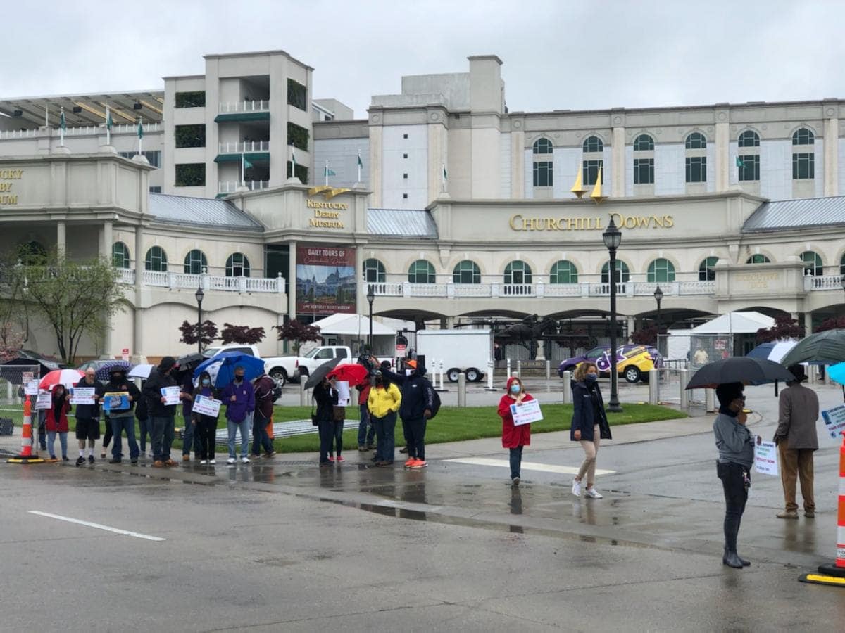 people protesting in rain