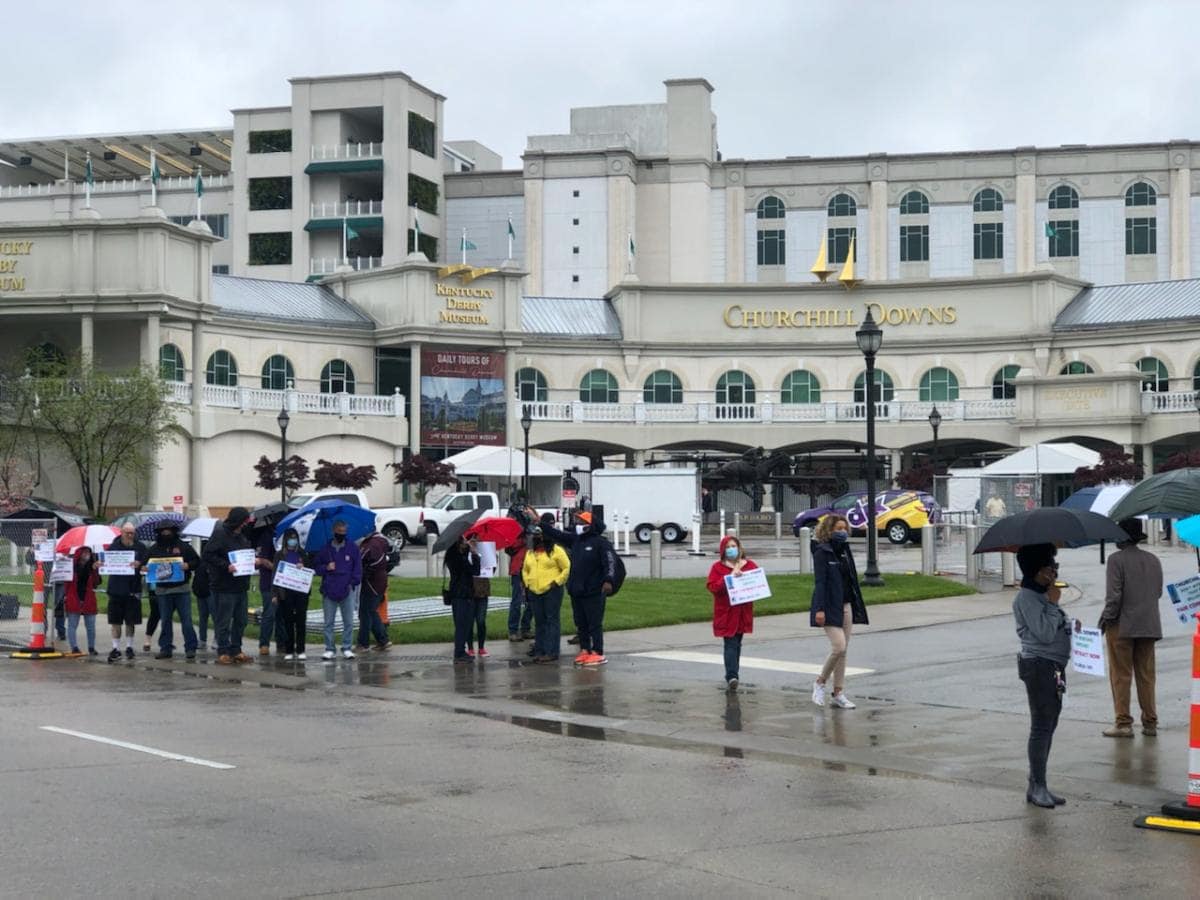 people protesting in rain