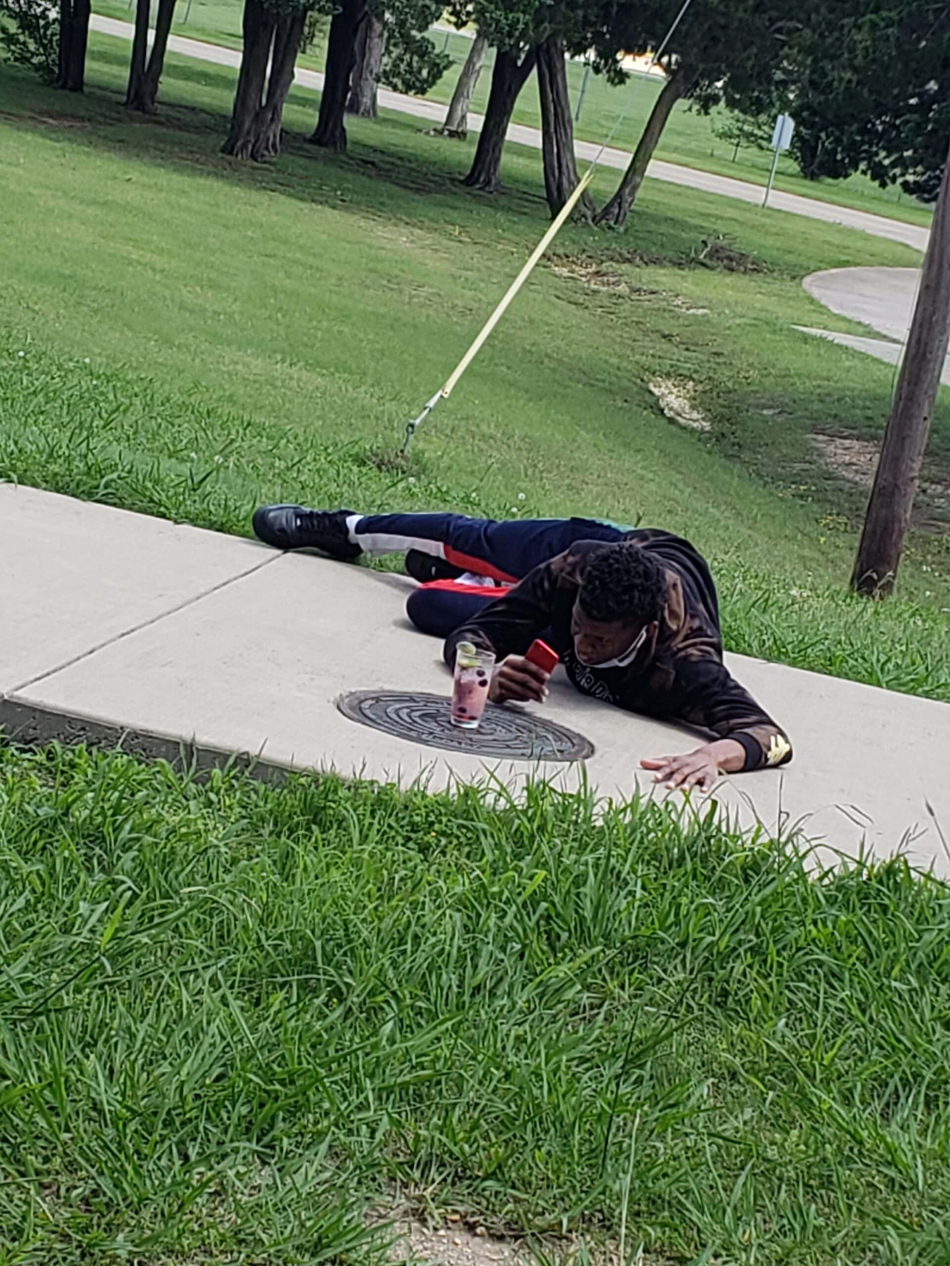 person lying on ground taking photo