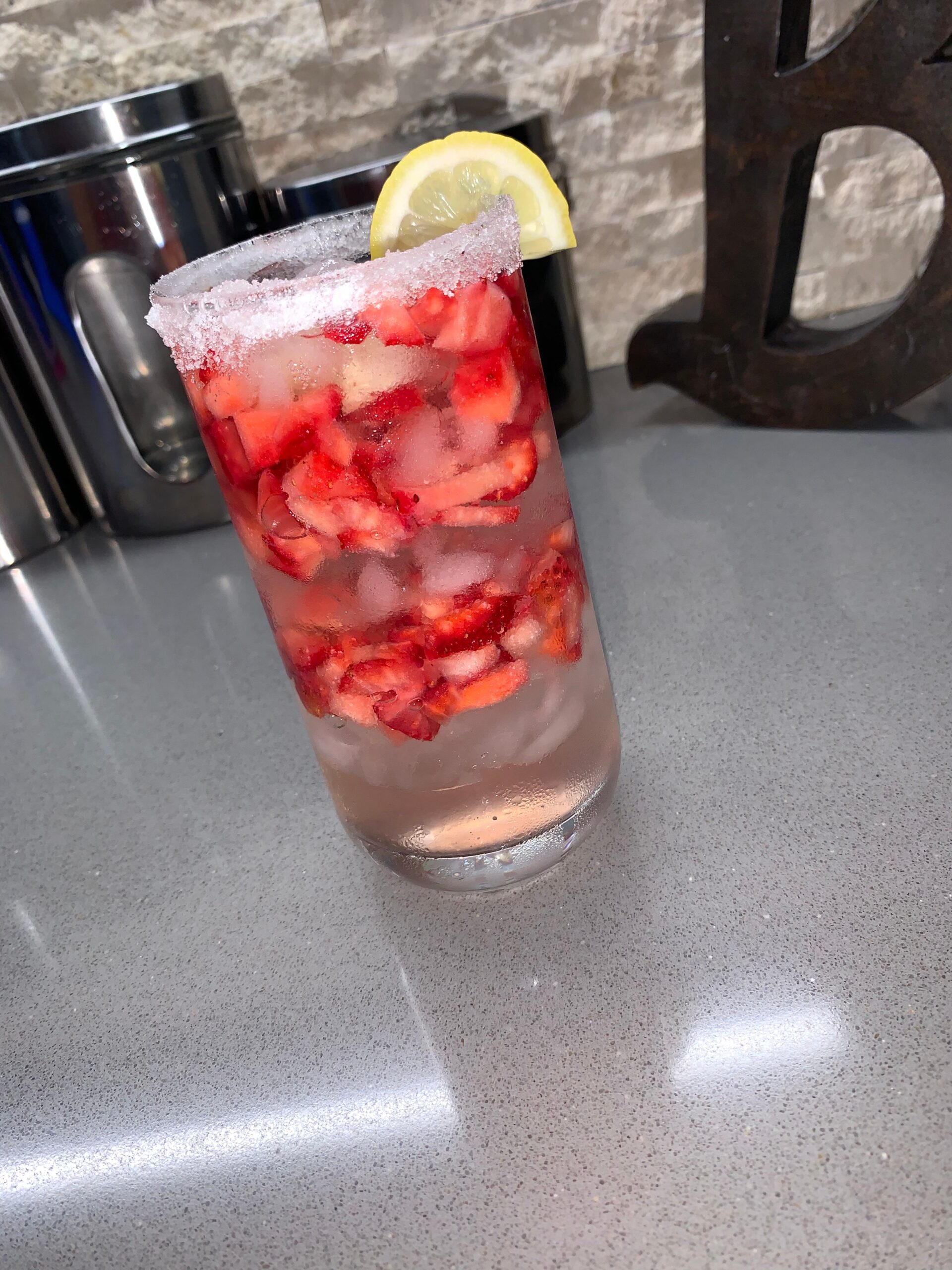 glass of water with lemon garnish