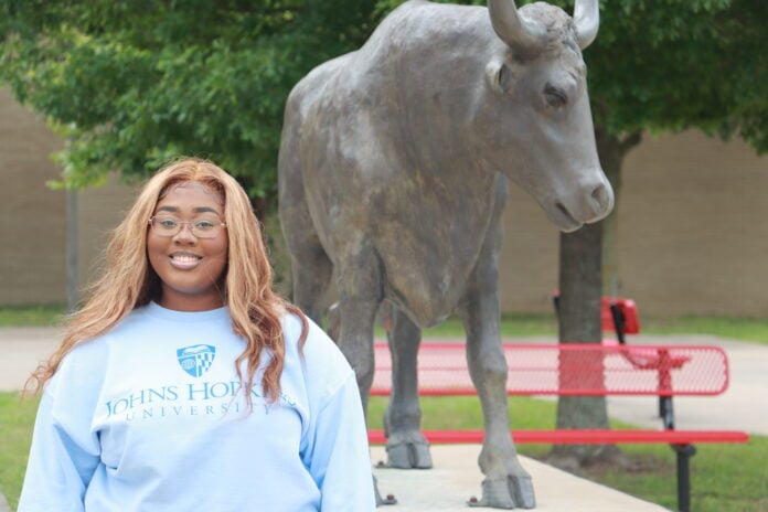 Gia Henderson with Longhorn statue